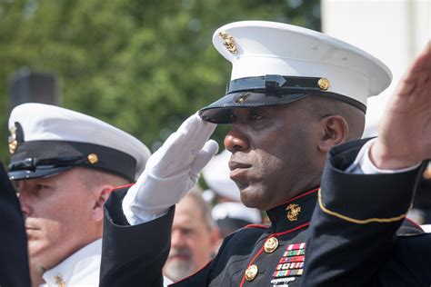 A Marine Corps ceremony with flags and dignitaries